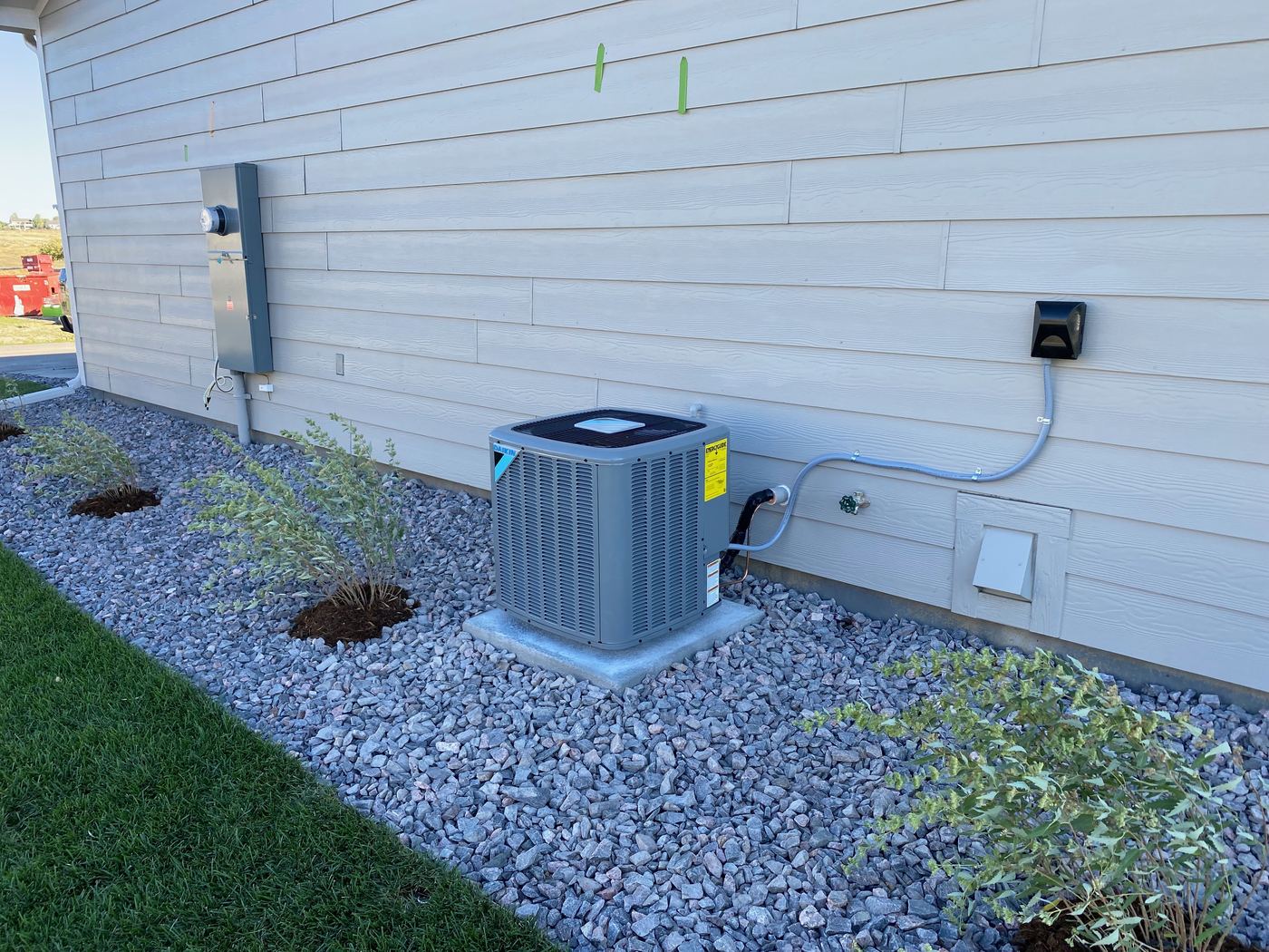Daikin central air conditioner on a pad
